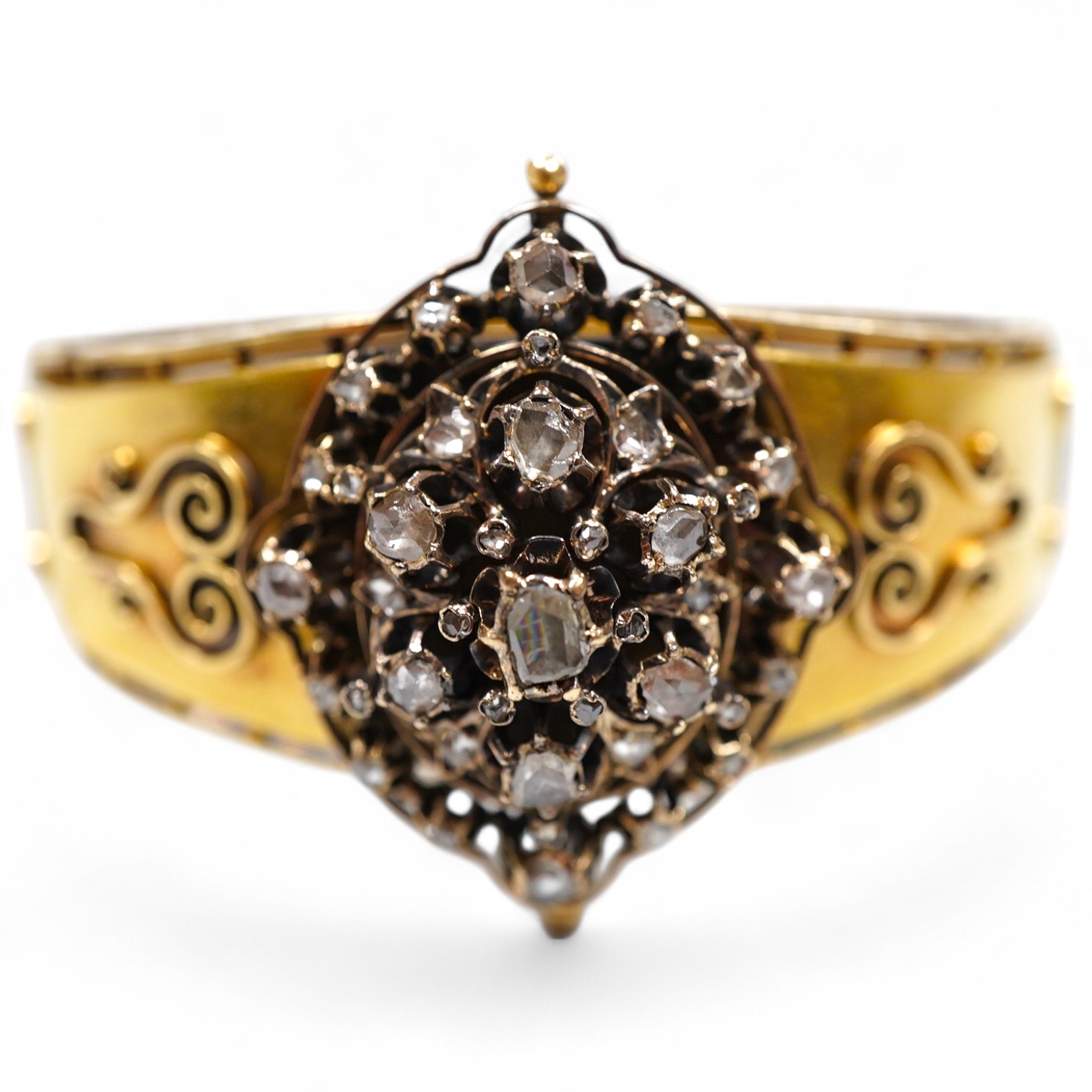 A Victorian gold and diamond bracelet, the hinged cuff decorated with wire scrollwork, centring on an oval motif set with rose-cut diamonds, inner circumference approximately 17cm, width at front 3.8cm, gross weight appr